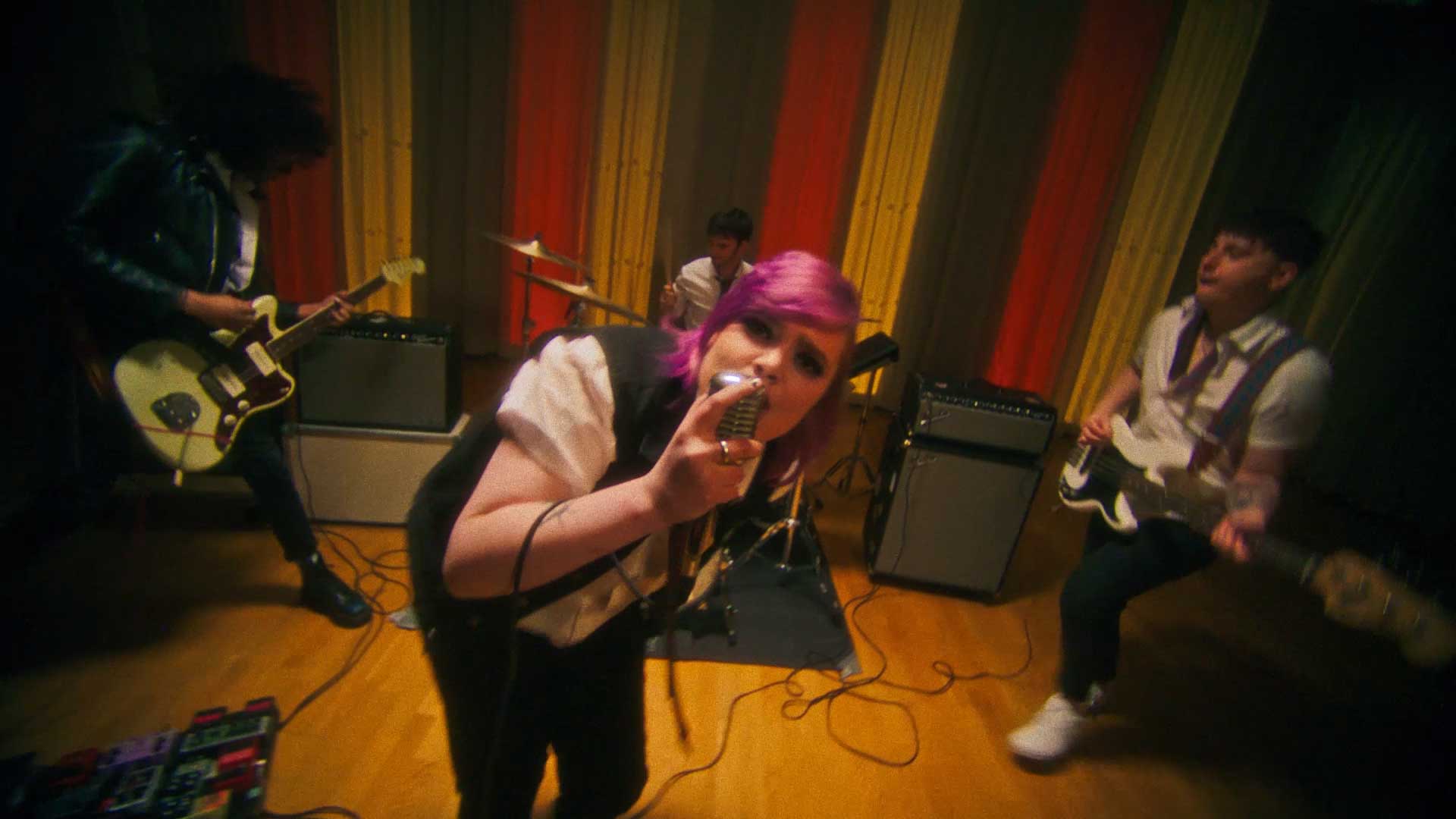 BLOXX band performing in a talent competition in a school assembly hall 